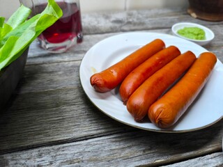 grilled sausages lie on a white plate