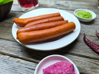 grilled sausages lie on a white plate