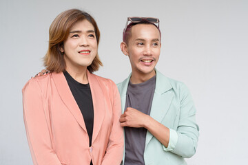 Transgender and non-binary coworkers against plain background