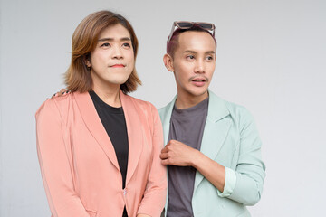 Transgender and non-binary coworkers against plain background