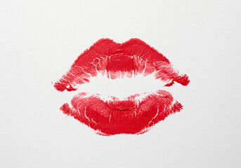 Close up of a red lipstick kiss mark on a white background in a centered symmetrical composition
