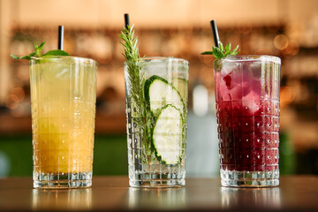 Refreshing trio of artisan cocktails with garnishes in elegant glasses on bar counter