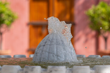Water Splash Close-up. A close-up of a fountain shows the water rushing upward in perfect clarity....