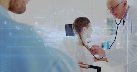 Listening physician using stethoscope on girl at exam table in clinic with clipboard and monitor