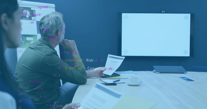 Reviewing documents man wearing green shirt at office meeting room, flip chart, copy space