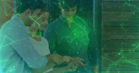 Collaborating four colleagues analyzing data overlay in office, handheld device showing world map