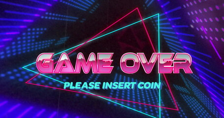 Neon arcade screen displaying glowing GAME OVER text and triangular outlines in dark gaming setup