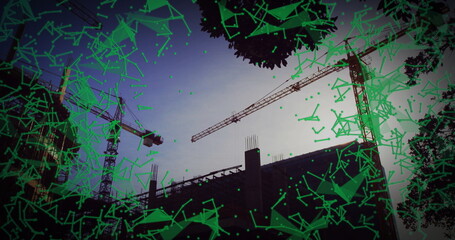 featuring three tower cranes around concrete frame at construction site at dusk, with green overlay