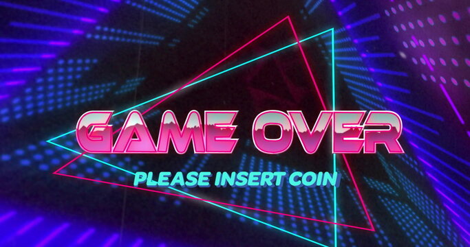 Neon arcade screen displaying glowing GAME OVER text and triangular outlines in dark gaming setup
