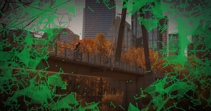 Standing man checking smartphone on park footbridge, with green overlay and cables, copy space - Powered by Adobe