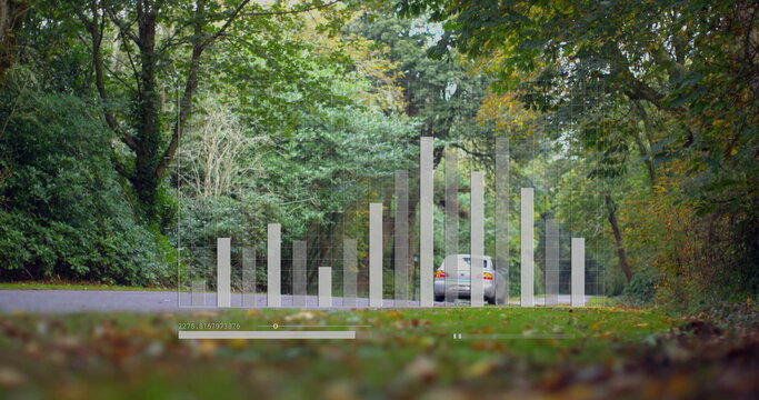 Fototapeta Showing silver sedan occupying frame on forest road, with faint bars and timeline slider overlay