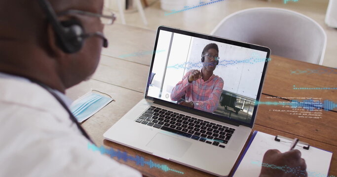 Showing consultant in red checked shirt speaking on online call in home office, with clipboard mask