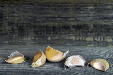 fresh garlic cloves on a vintage wooden background