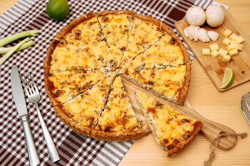 Cheese mushroom quiche with lime and herbs on checkered cloth background