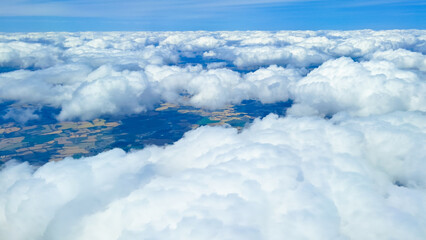 Cloud view from above representing global travel, tourism, and air movement.