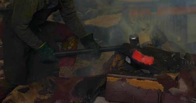 Smith kneeling with tongs placing rotating metal bar as code bits drifting merging, showing fusion