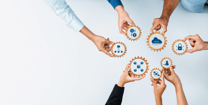 A diverse group of hands interacts with gears displaying icons that symbolize business data, security, and digital strategy, representing teamwork and collaboration in innovation. Amity - Powered by Adobe