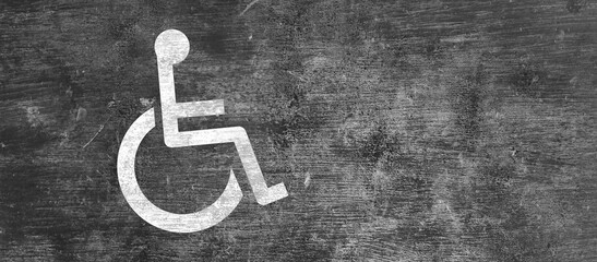 Accessibility symbol for people with disabilities, a wheelchair, drawn on a concrete wall