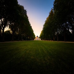 Grand Avenue Leading to an Elegant Mansion Under a Soft Sunset Sky