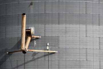 Grain chute attached to side of silo.