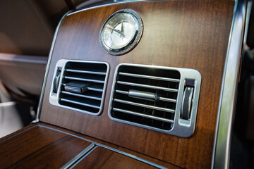 Experience the luxury of a meticulously designed car interior with refined wood finishes, sleek...