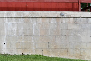 Cinder brick wall with electrical outlet. 
