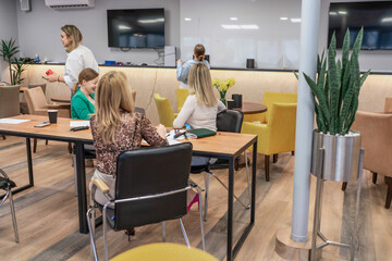 Office meeting collaboration: Employees brainstorm ideas in a bright office during a workday for...