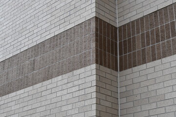 Dark colored brick building. Two corners, angled upward  shot. Old shopping mall.