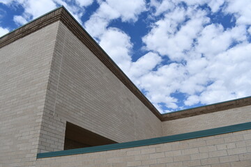 Complex brick building. Beautiful blue sky in background.