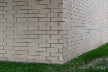 Damaged corner of brick wall. Large shopping mall.