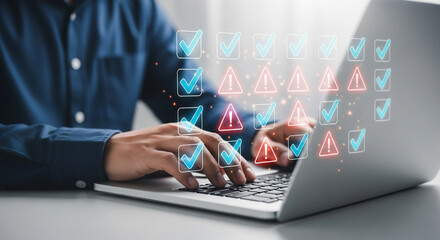 A person is using a laptop to manage a digital checklist with both completed tasks and potential issues, highlighting project management and quality control