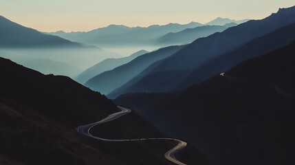 Winding Road Through Serene Mountain Layers at Dawn