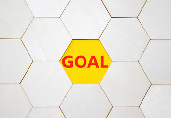 Goal symbol. Concept word Goal on wooden comb puzzle. Beautiful yellow background. Business and...