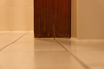 Massive water damage Moisture damage to a wooden door in the modern bathroom