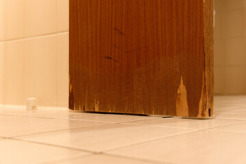 Massive water damage Moisture damage to a wooden door in the bathroom