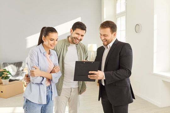 Family couple buying new apartment, listening to advice of real estate agent, estimating home value, discussing design project of house. Happy future homeowners talking with realtor