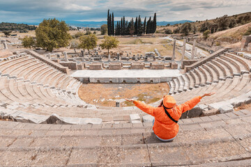 Tourist admiring the ancient Asklepion Theatre in Pergamon, Turkey, a world heritage site, showing...