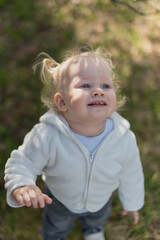 Close-up of a little girl's face with a smile and beautiful blue eyes, looking up