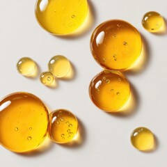 Natural aesthetic of golden oil drops reflecting light on a pristine white surface