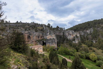 Hermitage of san bernabé embracing the canyon of the rio lobos natural park in soria, spain