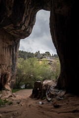 Obraz premium Tourist exploring hermitage of san saturio framed by cave opening in soria, spain