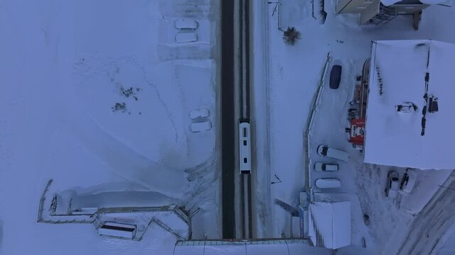 Winter drone panorama: Obertauern ski hamlet with bus carrying visitors