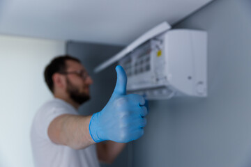 Skilled Technician Giving Approval After Successfully Installing a New Air Conditioning Unit for...