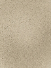 Beige crumbled concrete wall texture. Wonderful light-yellow backdrop.