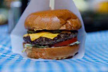Deliciously Juicy Cheeseburger Elevated by Fresh Vegetables and Tasty Condiments, Perfect for a Satisfying Meal at Any Time of Day or Night, Loaded with Flavor and Texture