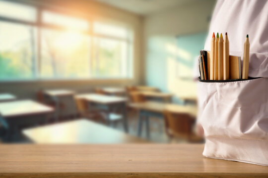 School backpack with supplies on classroom desk – back to school and education concept with product placement space. - Powered by Adobe