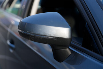 Close-Up View of a Car Side Mirror Captured in Natural Light, Showcasing the Metallic Finish and...