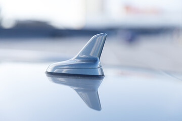 Close-up View of a Car's Antenna with Reflection on the Surface, Showcasing a Sleek and Modern...