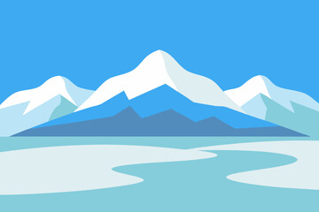 Winter mountain landscape with snow-capped peaks under a blue sky, offering a panoramic view of cold, serene nature