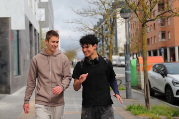 Two teenager boy walking, race diversity, students portrait